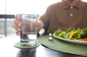 Glass of water and salad on a plate