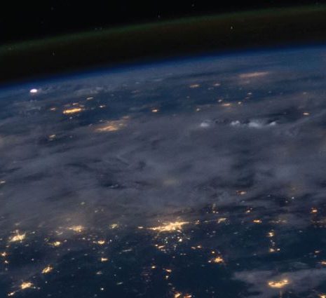 The earth from outer space, looking at the clouds and cities from above.