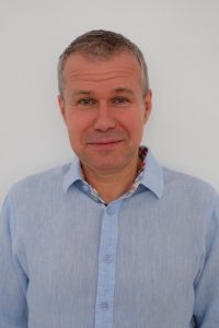 head shot of Prof. Peter Juni wearing blue button down shirt