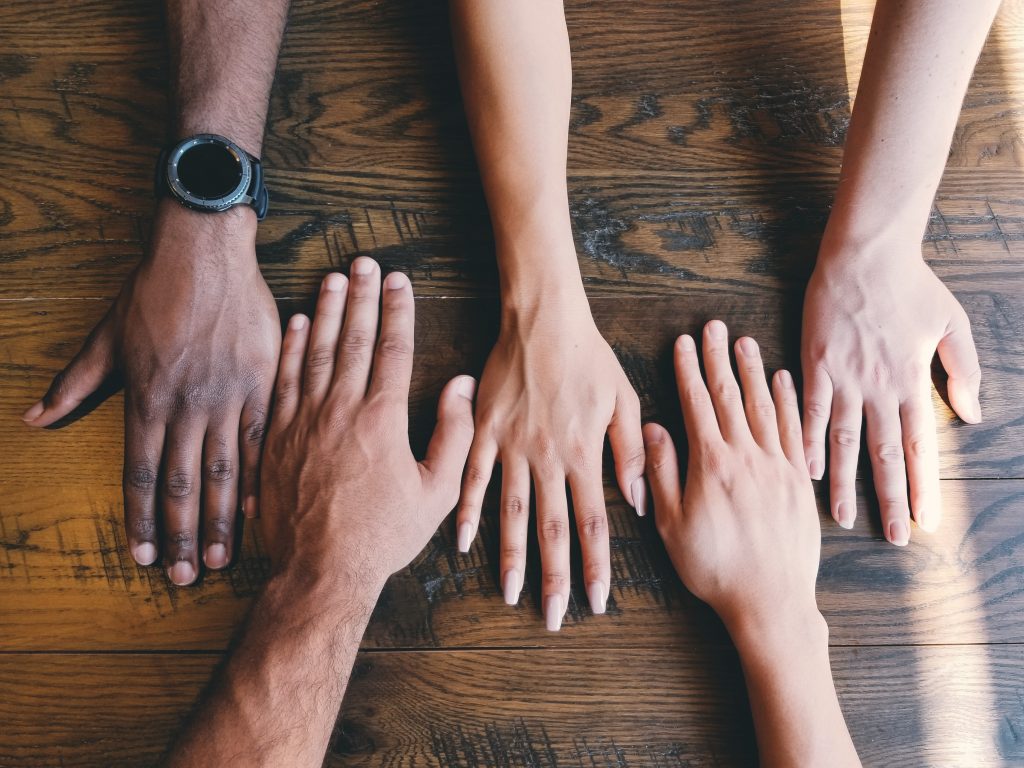 photo of hands on a table facing down