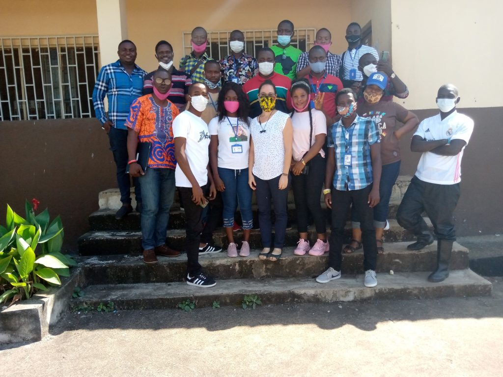 Ashley Aimone pictured with survey team in Sierra Leone pictured standing on steps infront of a building