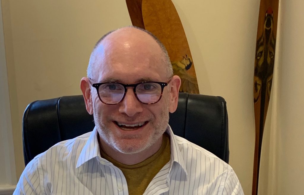 Neil Seeman head shot, glasses, white collared shirt