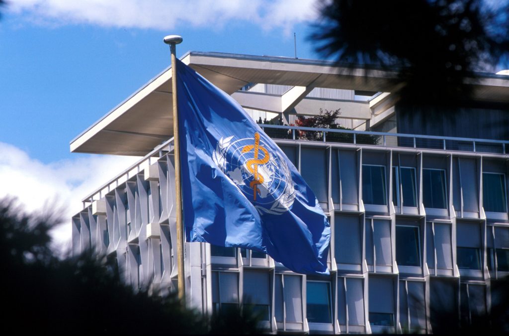 WHO headquarters with WHO flag