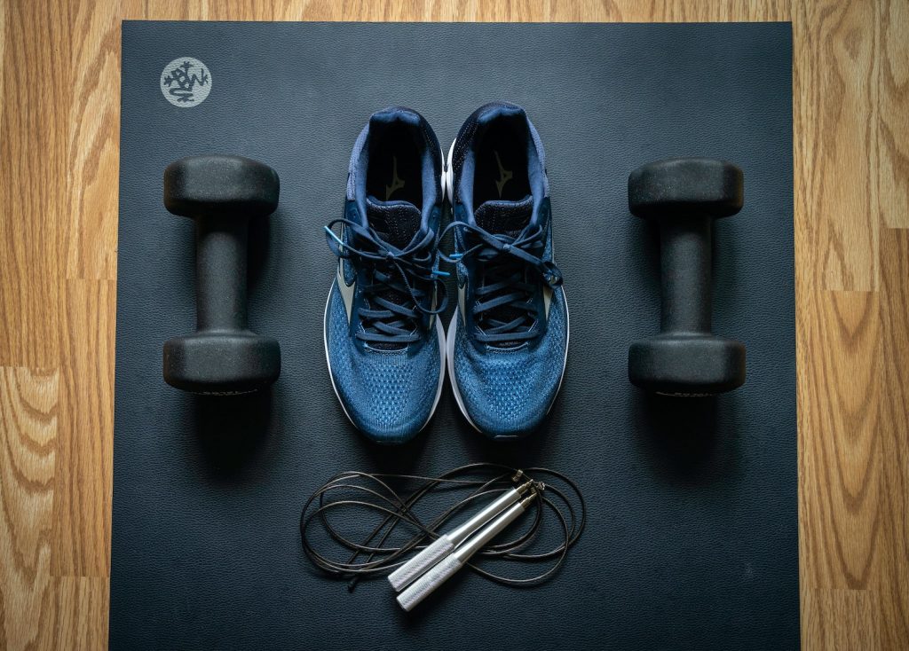 image of shoes and weights on a black mat