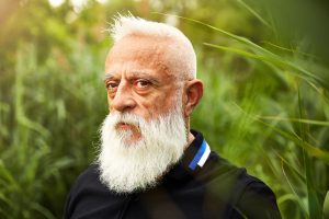 Francisco head shot, foliage in background, dark polo shirt