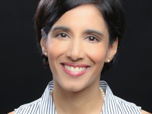 head shot, smiling, short hair, red lipstick, sleeveless striped blouse