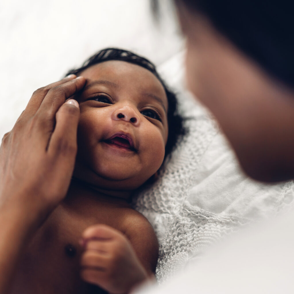 a baby looking at its mother