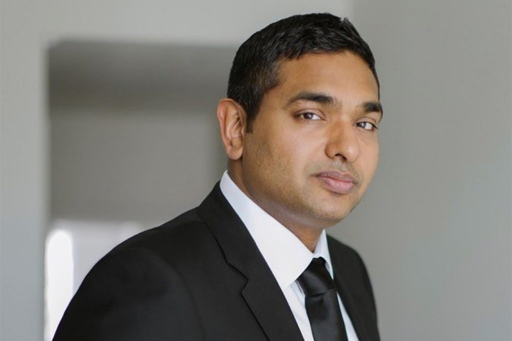 head shot of Prof. Fahad Razak in dark suit and tie
