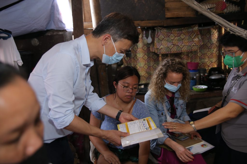 Prof. Xiaolin Wei reviews a document alongside his colleagues in the Philippines.