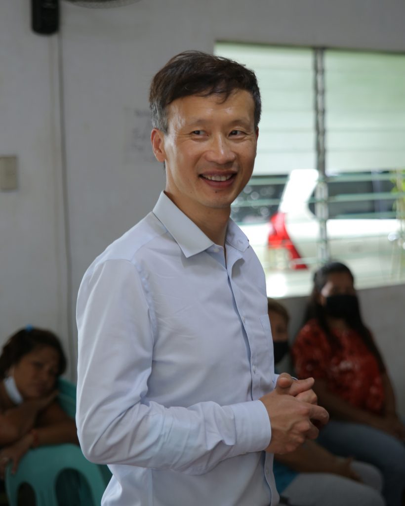 Prof. Xiaolin Wei smiles during a pause in his presentation.