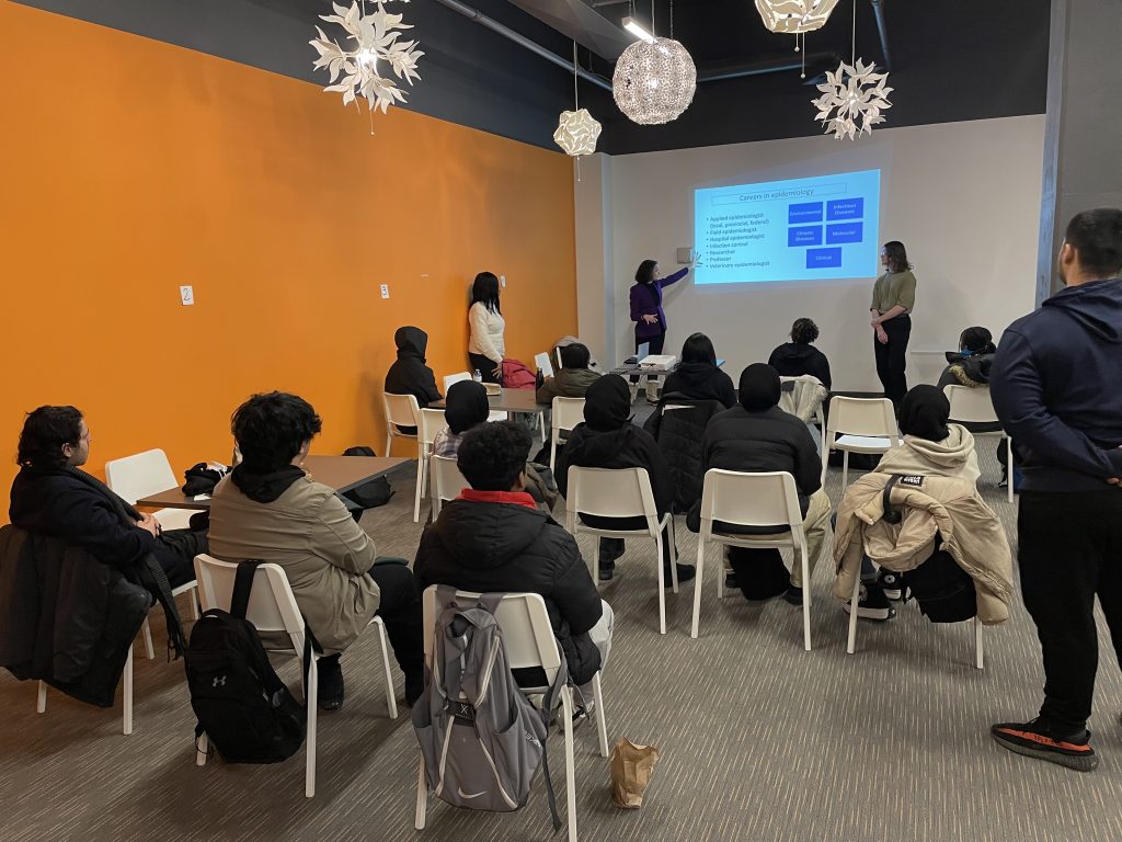 Professor Laura Rosella and two PhD students introducing students in Lawrence Heights community to epidemiology and its career paths.