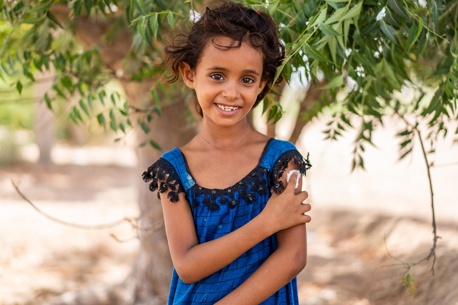 7-year-old Hind Ali Nasser holds her arm after being vaccinated in Aden Governorate, Yemen. (UNICEF)