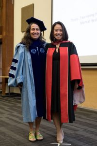 Doctoral graduate Peggy Chi poses with Prof. Dionne Gesink immediately after being hooded by Gesink at the DLSPH Hooding Ceremony.