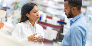 Image of a pharmacist helping a patient, as part of the 2023 New Initiative and Innovation Awards article