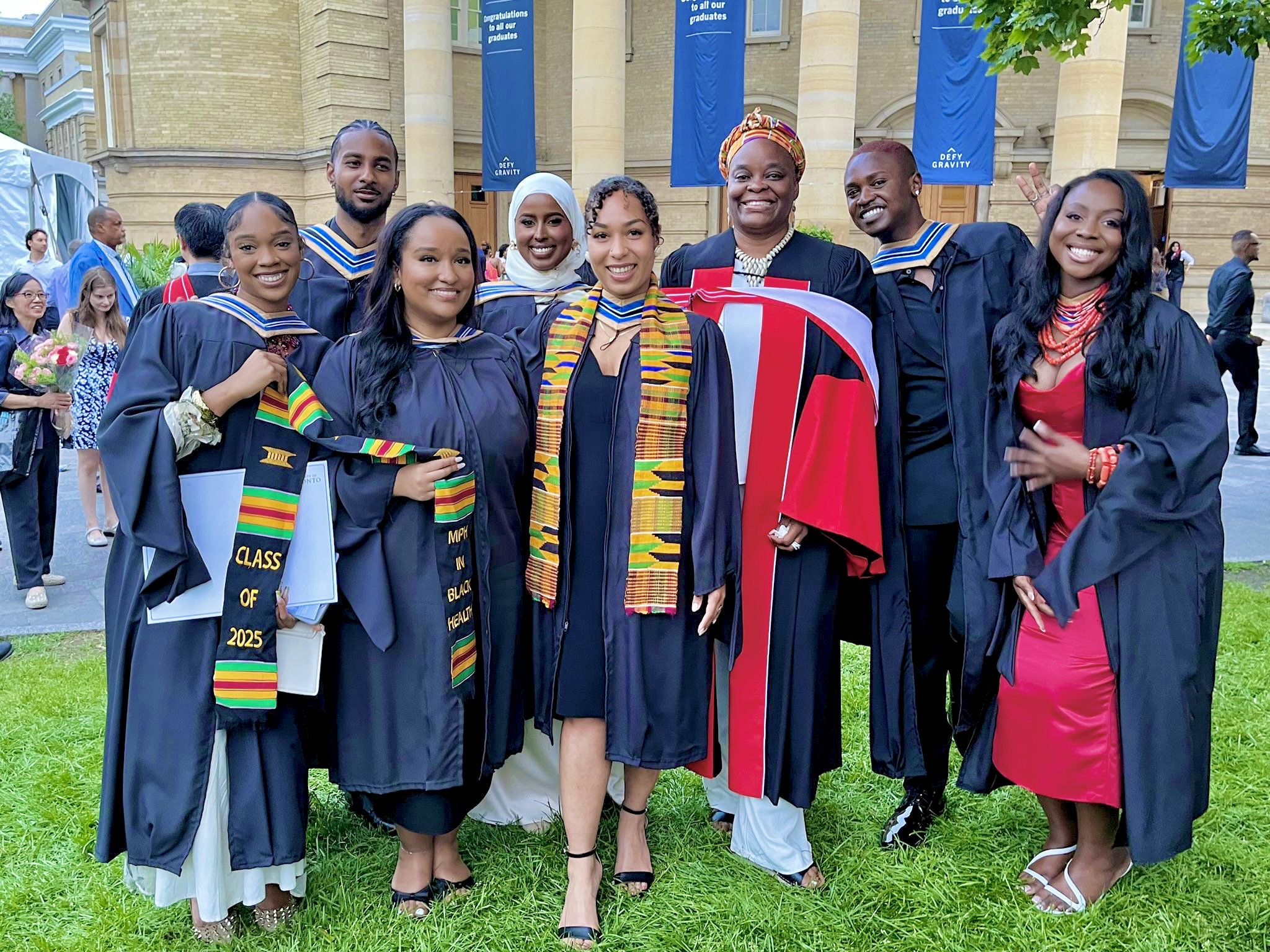 A group shot of the MPH in Black Health program graduates on the lawn in their gowns